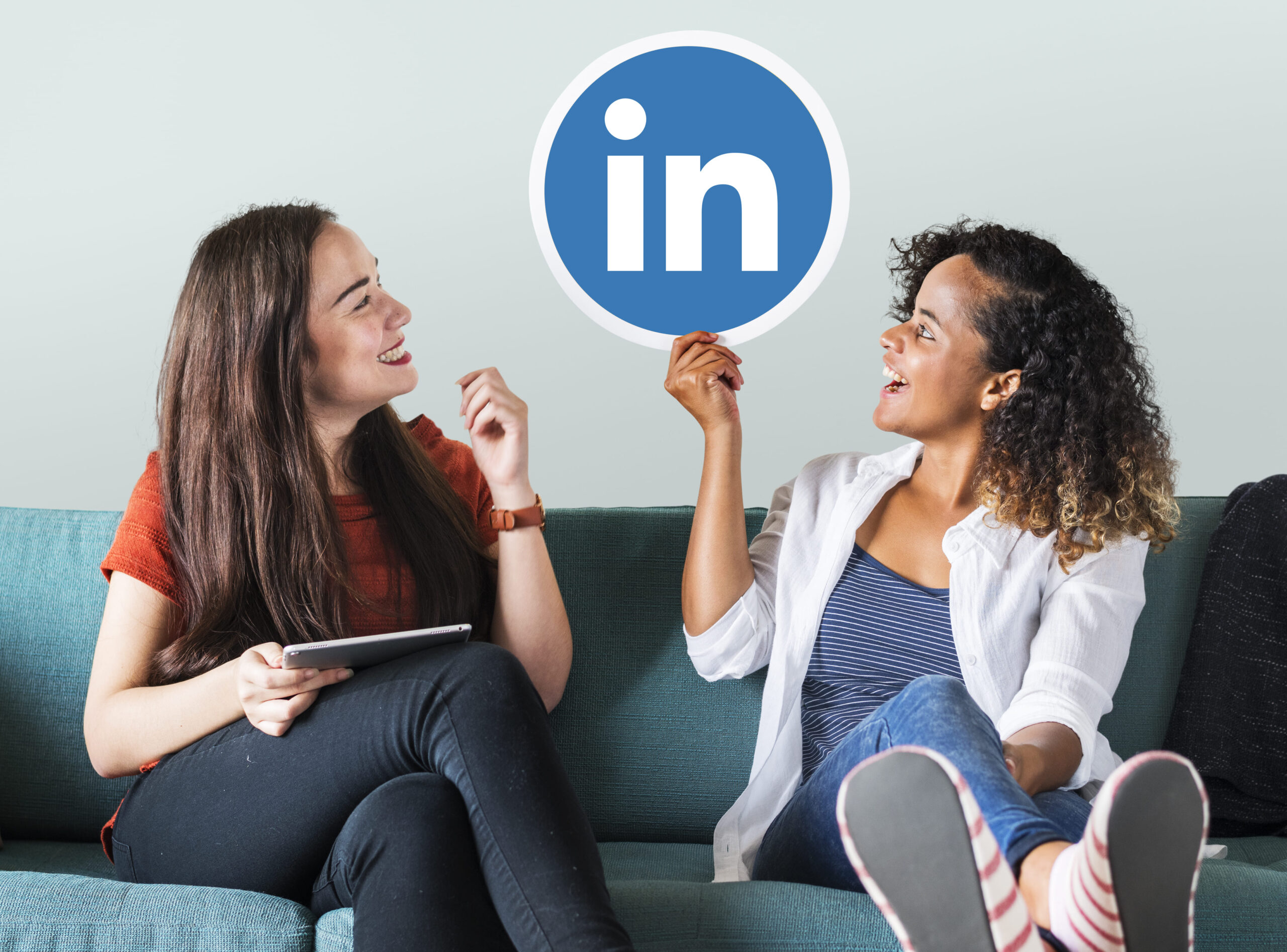 linkedin: duas mulheres segurando uma placa do linkedin